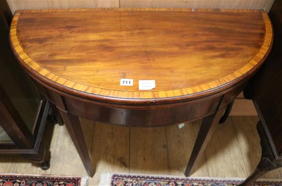 A George III mahogany and tulipwood banded D shape card table W.91cm